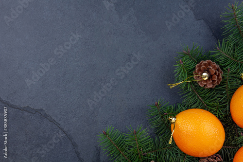 Christmas background with pine tree cones, pine tree branches and oranges. zero waste concept