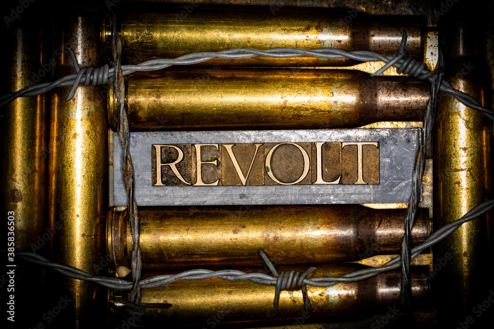 Naklejka premium Revolt text message on lead bars between copper 50 caliber gun casings on vintage textured grunge copper and gold background lined with barbed wire