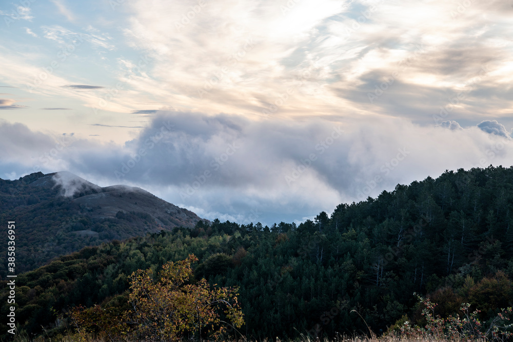 sunrise in the mountains with morning fog from early autumn