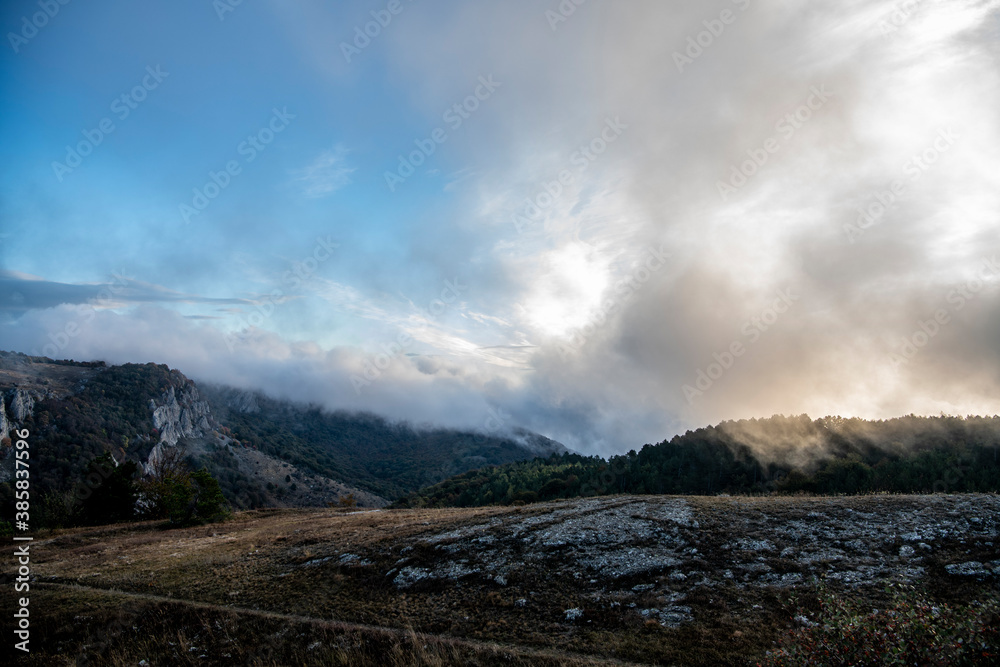 sunrise in the mountains with morning fog from early autumn