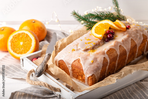 Christmas orange cake with cranberries and sugar icing photo