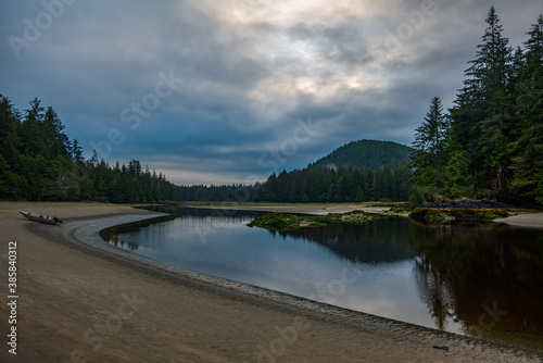 The beautiful San Josef River on a cloudy morning with reflection in Cape Scott Provincial park on Vancouver Island, British Columbia, Canada.