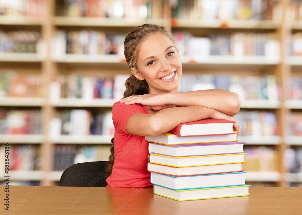 Young female college student and stack of book Young female college student and stack of book
