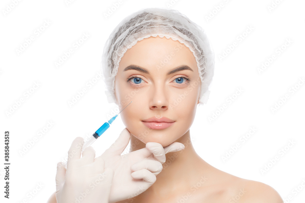 Portrait of young female wearing medical cap, getting ready for face lifting to eliminate aging effect, isolated on white background Portrait of young female wearing medical cap, getting ready for face lifting to eliminate aging effect, isolated on white background
