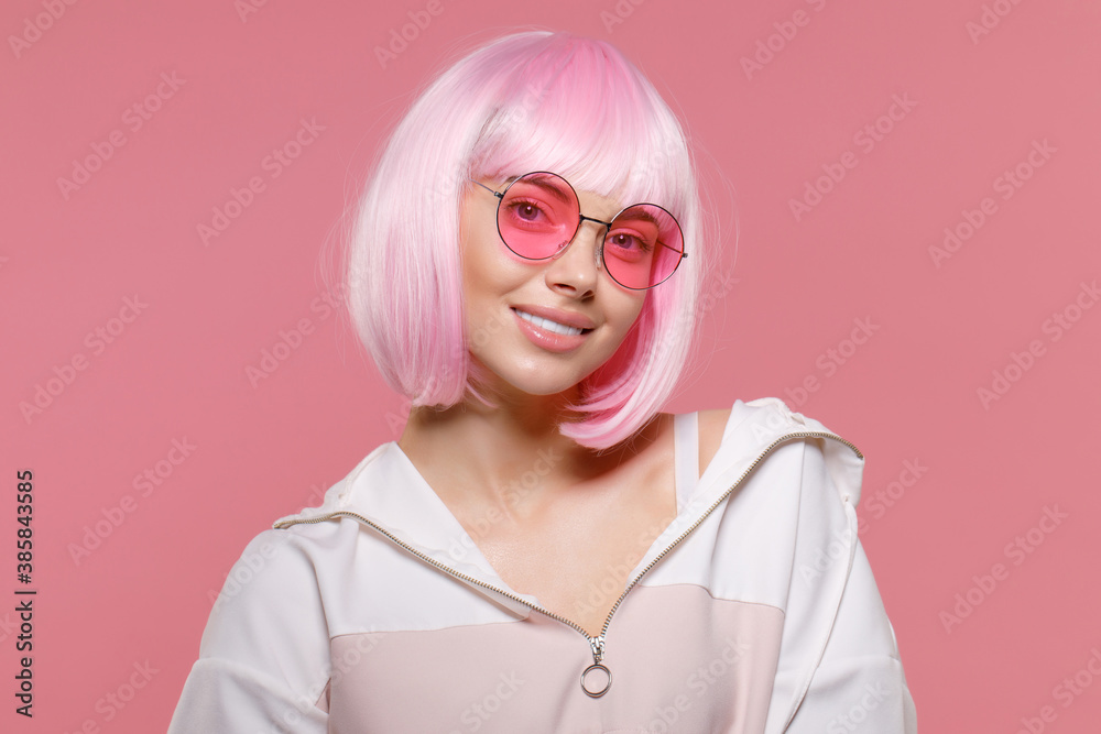 Young beautiful smiling woman with pink hair is getting ready for a party Young beautiful smiling woman with pink hair is getting ready for a party