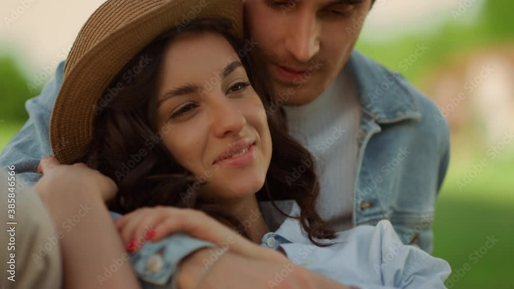 Affectionate couple spending time on picnic. Girl and guy lying on grass Affectionate couple spending time on picnic. Girl and guy lying on grass
