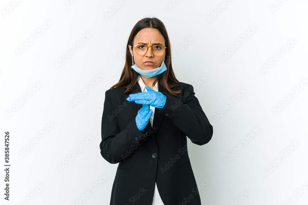 Young business latin woman wearing a mask to protect from covid isolated on white background showing a timeout gesture. Young business latin woman wearing a mask to protect from covid isolated on white background showing a timeout gesture.