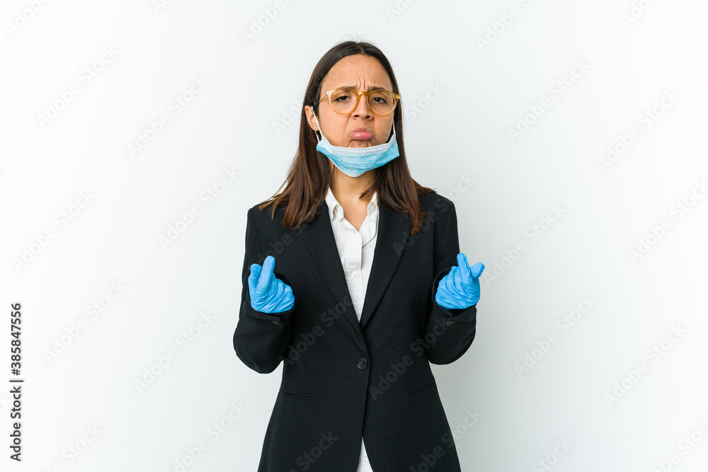 Young business latin woman wearing a mask to protect from covid isolated on white background showing that she has no money. Young business latin woman wearing a mask to protect from covid isolated on white background showing that she has no money.