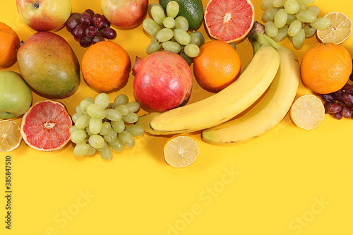 Tropical fruits  grapefruit  orange  lemon on a yellow background  banner. Detox diet minimal concept. Space for text  flat lay. Healthy and natural food concept. Vitamins C lifestyle