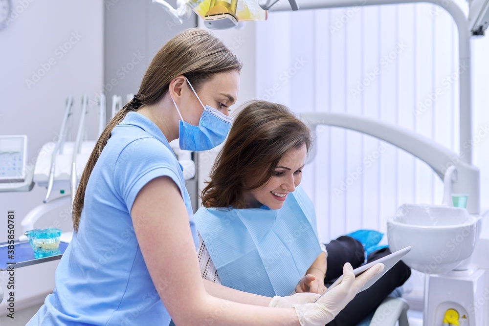 Dentistry, dental treatment, woman doctor dentist consults patient in chair