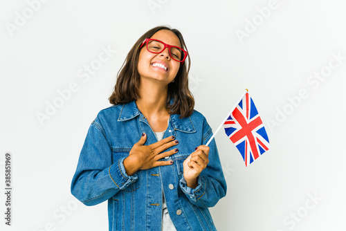 Photography Young latin woman holding a english flag isolated on white background