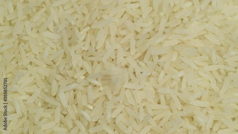 White rice raw grains falling, slow motion, close up White rice raw grains falling, slow motion, close up
