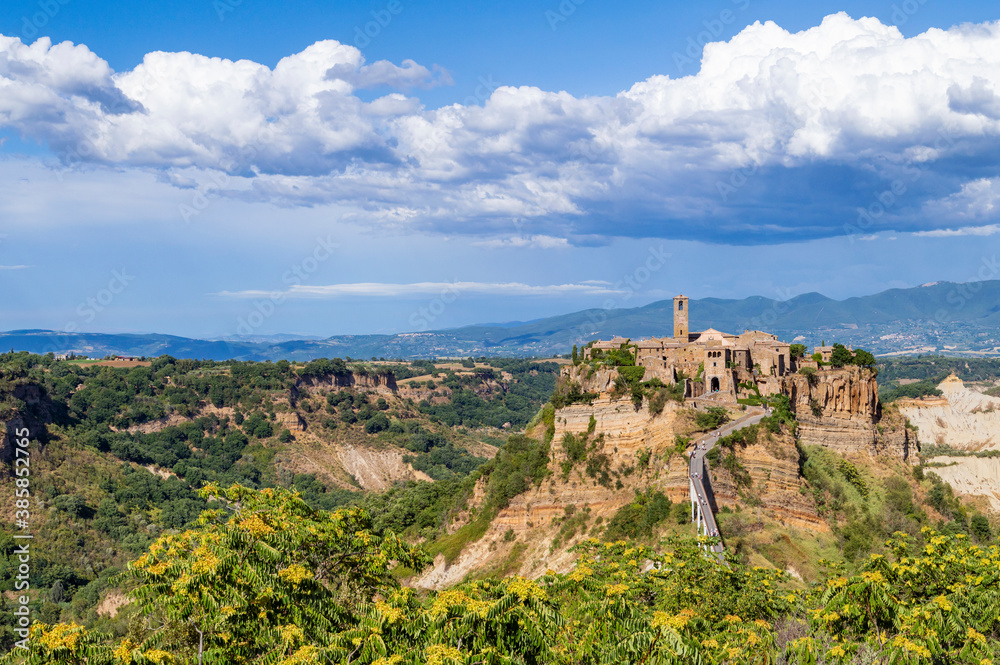 Picturesque panoramic view of Civita di Bagnoregio, the medieval town surrounded by clouds. The village on the top a plateau of volcanic tuff known as The Dying Town, Viterbo provence, Lazio, Italy.