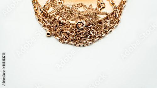 Bijouterie. Gold chains and a beautiful golden box on a white background. Jewelry concept