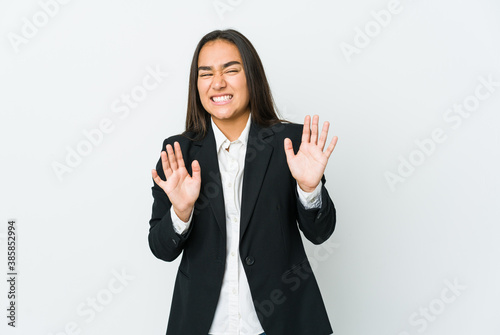 Young asian bussines woman isolated on white background rejecting someone showing a gesture of disgust.