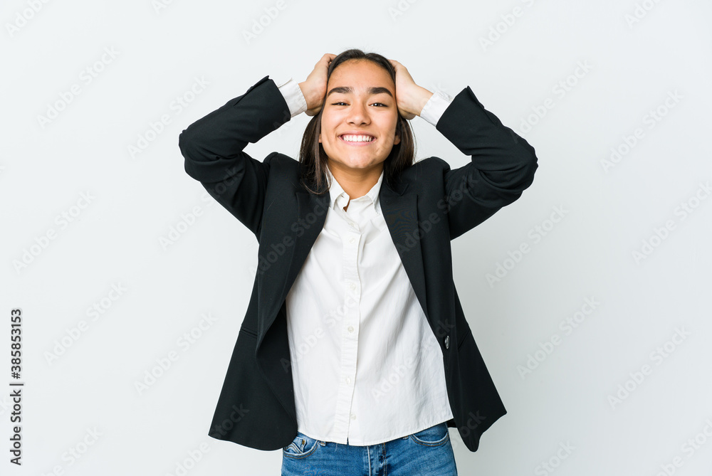 Young asian bussines woman isolated on white background laughs joyfully keeping hands on head. Happiness concept. Young asian bussines woman isolated on white background laughs joyfully keeping hands on head. Happiness concept.