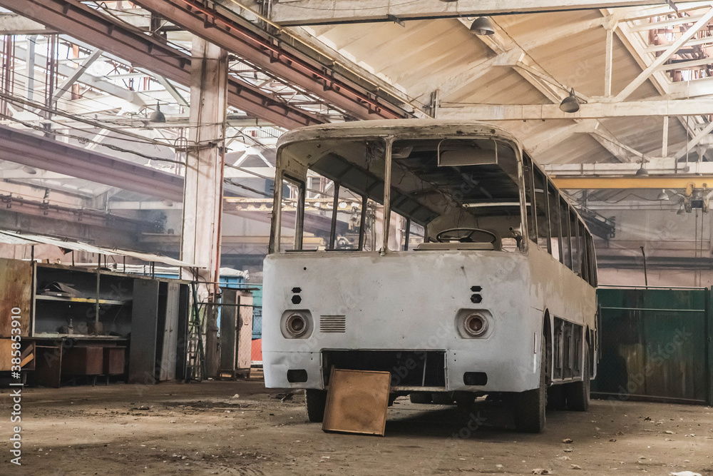 Old disassembled bus in an abandoned factory Old disassembled bus in an abandoned factory