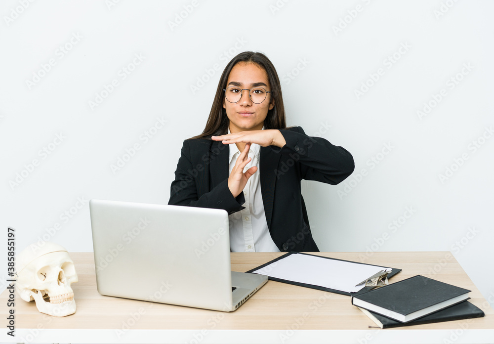 Young traumatologist asian woman isolated on white background showing a timeout gesture. Young traumatologist asian woman isolated on white background showing a timeout gesture.