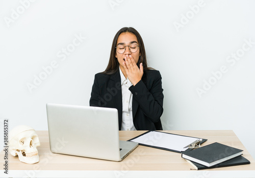 Young traumatologist asian woman isolated on white background yawning showing a tired gesture covering mouth with hand.