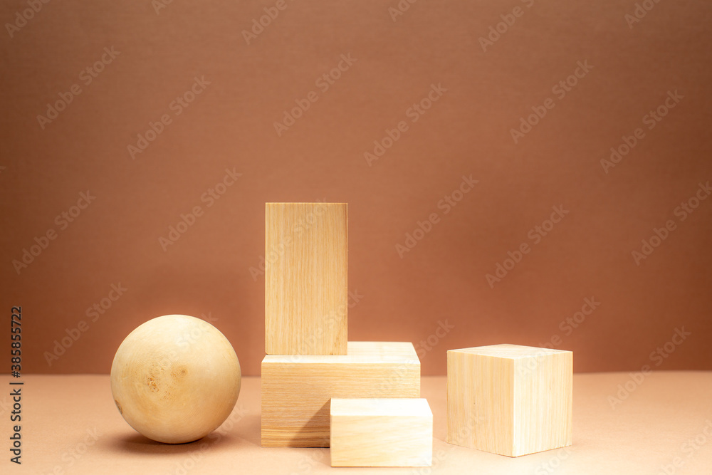 Conceptual Background with light wooden podiums and wooden ball on beige background for branding,identity and packing presentation of your product. Trendy still life on monotone tones. Conceptual Background with light wooden podiums and wooden ball on beige background for branding,identity and packing presentation of your product. Trendy still life on monotone tones.