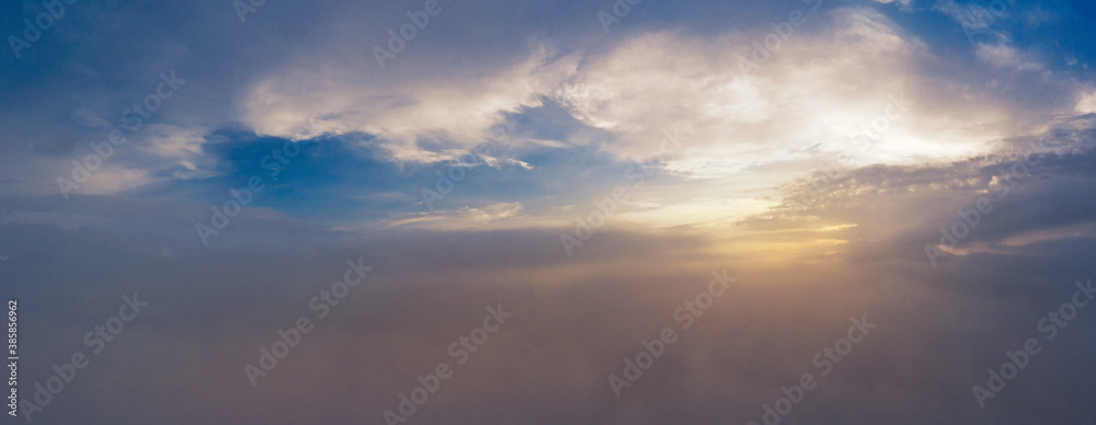 Beautiful sunrise over cloudy sky. View from the drone above the clouds.