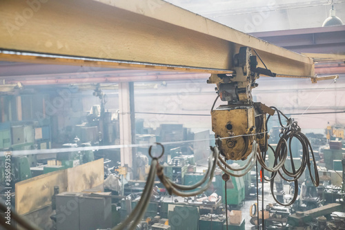 old crane under the roof of a factory photo