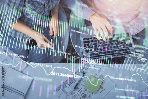 Multi exposure of man and woman working together and forex graph hologram drawing. Financial analysis concept. Computer background. Top View.