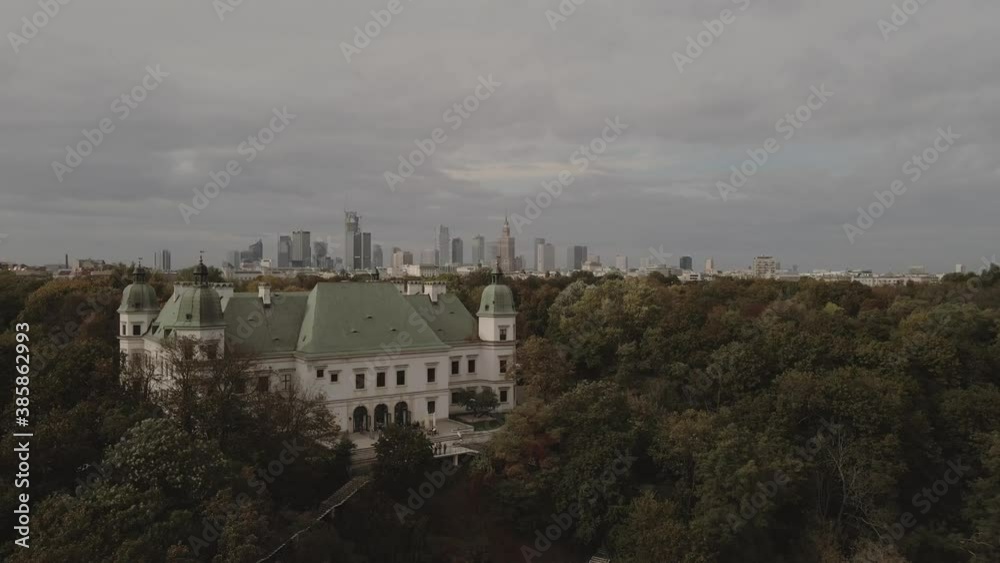 Old palace in city park with contrast of downtown buildings skyscrapers on background. Old palace in city park with contrast of downtown buildings skyscrapers on background.