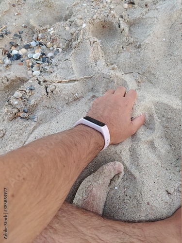 Feet on the beach, Hand with fitness bracelet