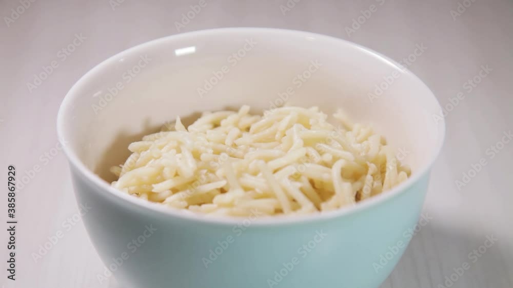 Spaghetti pasta with tomato sauce in white and blue bowl, white wooden background and resting straw plate and cutlery on the side, Brazilian cuisine copy space, top view. Food concept. Pasta concept. Spaghetti pasta with tomato sauce in white and blue bowl, white wooden background and resting straw plate and cutlery on the side, Brazilian cuisine copy space, top view. Food concept. Pasta concept.