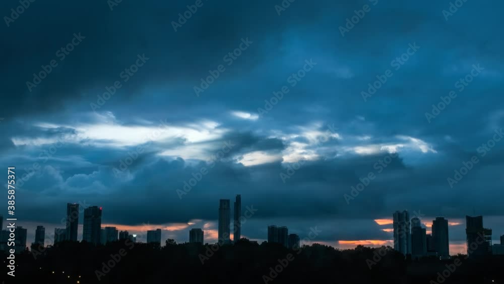 Dramatic timelapse shot of skyline with skyscraper silhouette and dark thunder clouds at sky. Dramatic timelapse shot of skyline with skyscraper silhouette and dark thunder clouds at sky.