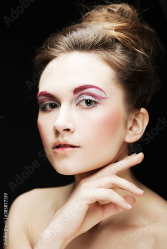 young female face with bright fashion multicolored make-up