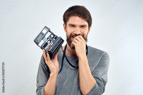 Male photographer professional camera work Studio Technology modern art light background © SHOTPRIME STUDIO