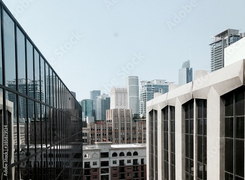View of downtown from the top floor of a building. Framed by two buildings. Fashion District, Los Angeles, California.