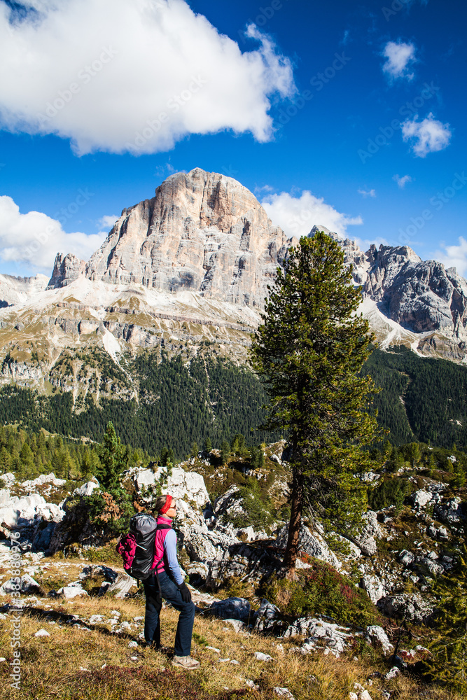 A woman hiking in the mountains, The Dolomites, Italy