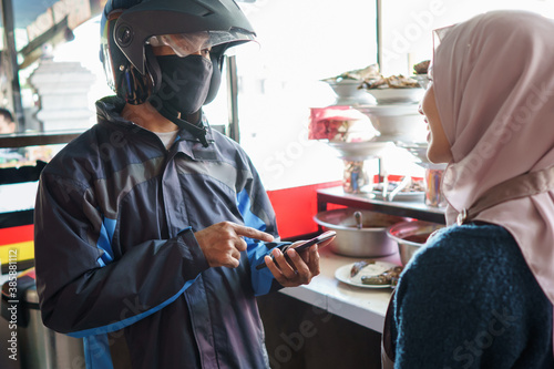 a man orders padang food according to customer orders photo