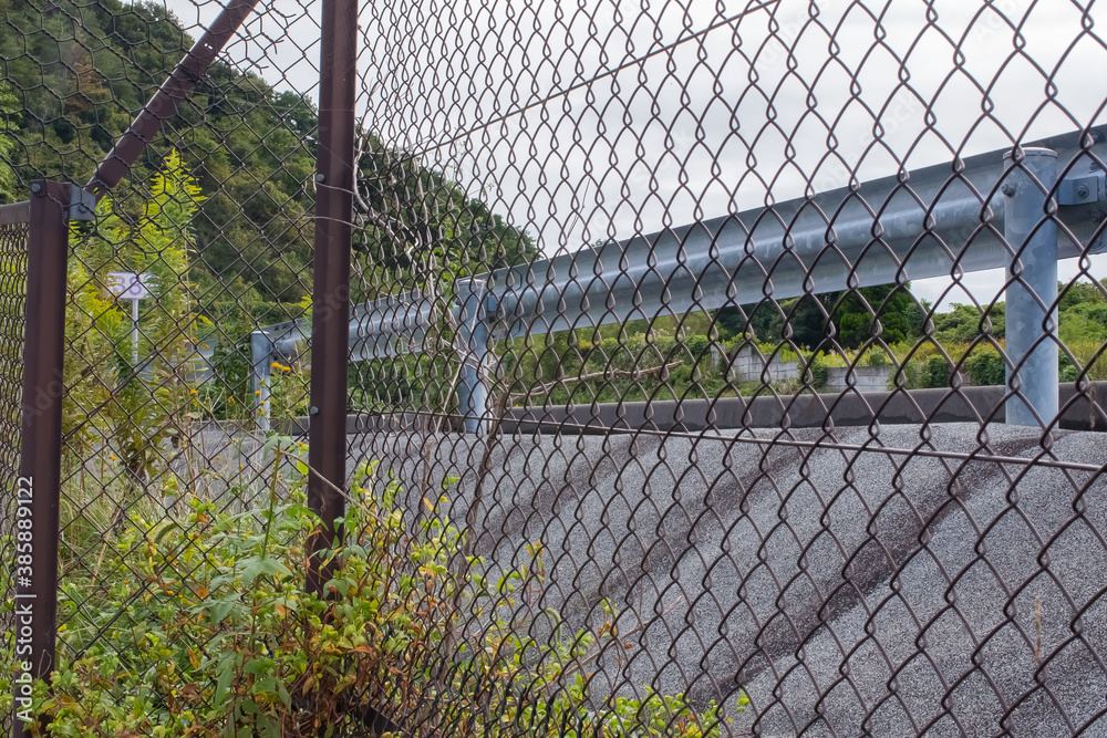 highway seen through the fence highway seen through the fence