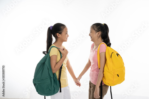 two couple student meet friend carrying bag and books in casual clothes isolated in white background photo