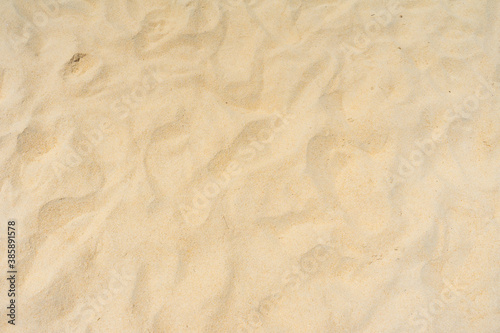 Closeup shot of sand texture on the beach as nature background. Wallpaper and background concept.