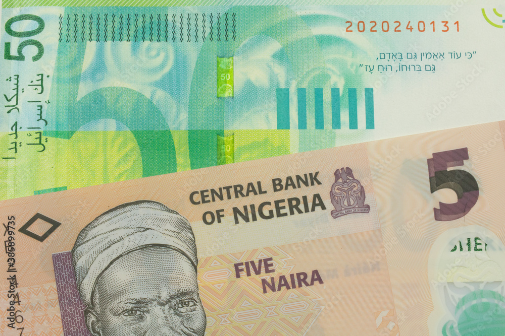Naklejka premium A macro image of a orange, plastic five naira note from Nigeria paired up with a green and white fifty shekel bank note from Israel. Shot close up in macro.