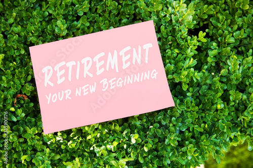 Motivational inspirational quote retirement your new beginning written on paper in a garden with green plants. © Cagkan