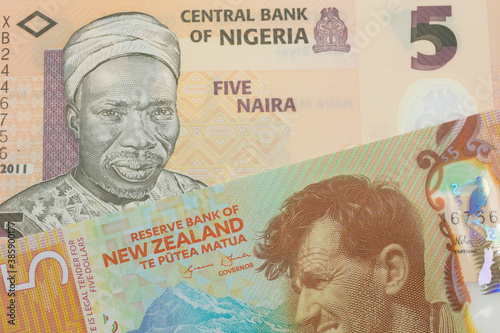 Wallpaper Mural A macro image of a orange, plastic five naira note from Nigeria paired up with a orange, plastic five dollar bill from New Zealand.  Shot close up in macro. Torontodigital.ca