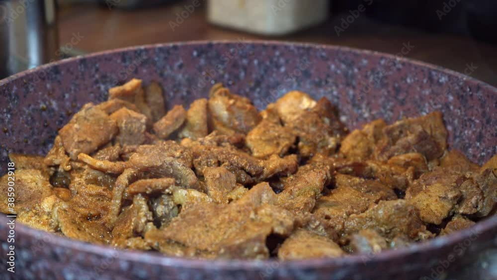 frying pan with meat in a kitchen. closeup frying pan with meat in a kitchen. closeup