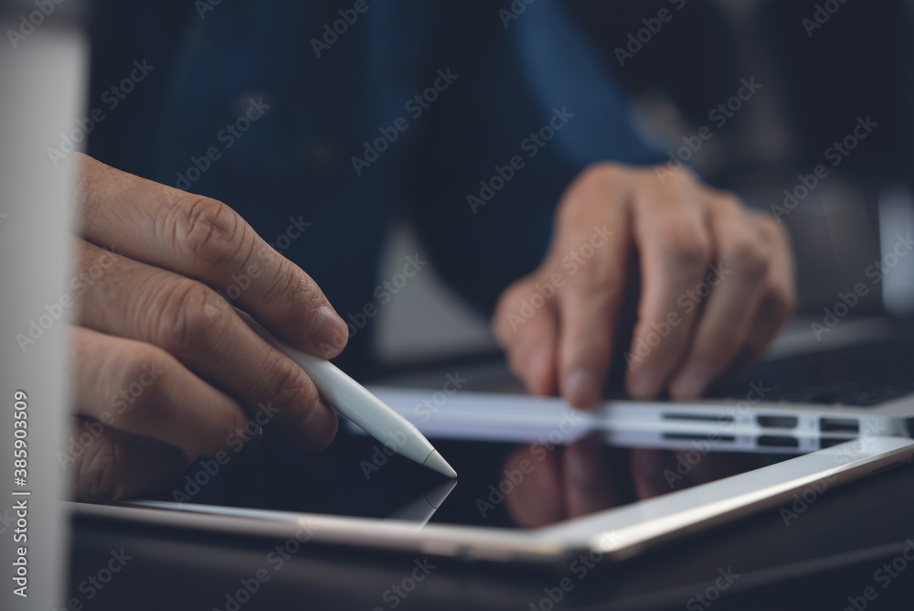 Business man using stylus pen signing on digital tablet while working in office for E signing electronic signature concept Business man using stylus pen signing on digital tablet while working in office for E signing electronic signature concept
