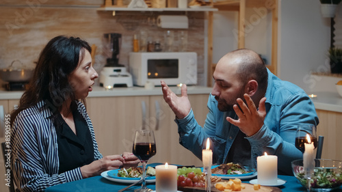 Angry man for positive pragnancy test during romantic dinner. Woman surprising her husband being pregnant, unhappy, nervous, partner, unwanted baby, frustrated for results.