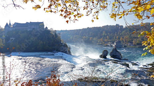 Autumn view on Rhine waterfall in Switzerland with castle and rocks
