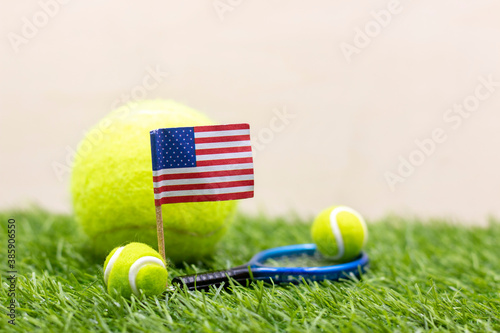 Tennis USA with Flag of America with tennis ball and racket are on green grass