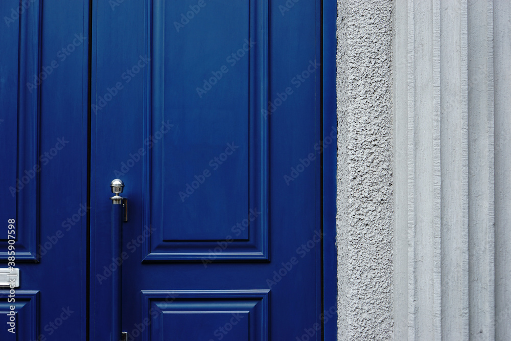 Blue wooden door with moldings.