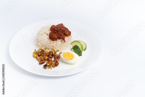 Nasi Lemak-Malaysian cuisine. A fragrant rice dish cooked in coconut milk and pandan leaf commonly found in Malaysia. A white background provides copy space to the