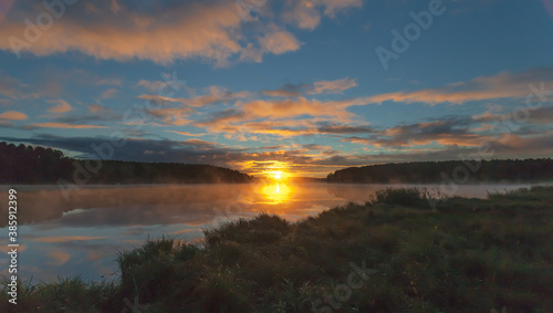 Summer dawn on a pond with fog